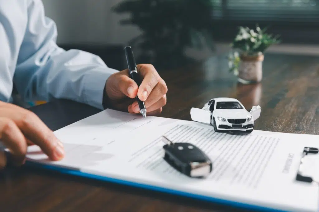 Businesswoman,Signing,Car,Insurance,Document,Or,Lease,Paper.,Writing,Signature Weingart Firm